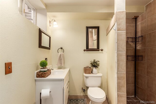 9861 Pecos St, Thornton, CO 80260 - bathroom featuring vanity, a tile shower, and tile patterned floors