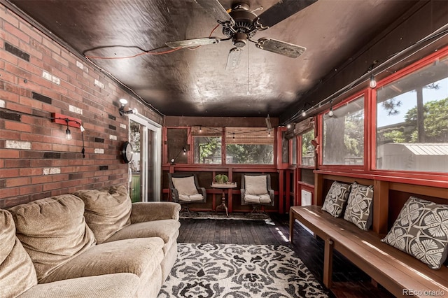 9861 Pecos St, Thornton, CO 80260 - sunroom with wood-type flooring, ceiling fan, plenty of natural light, and brick wall