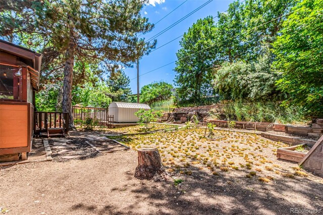 9861 Pecos St, Thornton, CO 80260 - view of yard with a storage unit and a vegetable garden