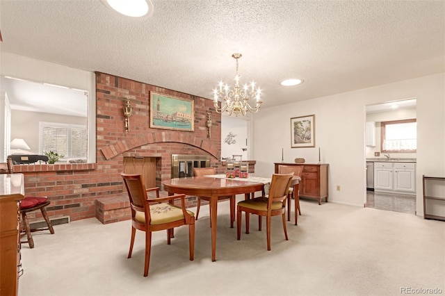 carpeted dining space with a textured ceiling, an inviting chandelier, and plenty of natural light