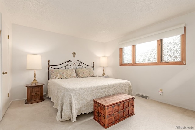 carpeted bedroom with a textured ceiling