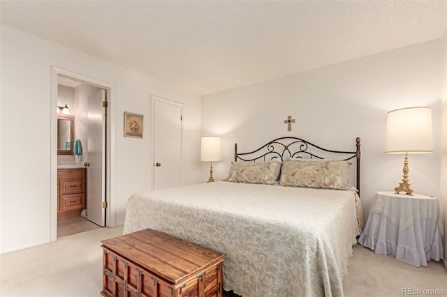 carpeted bedroom featuring ensuite bathroom