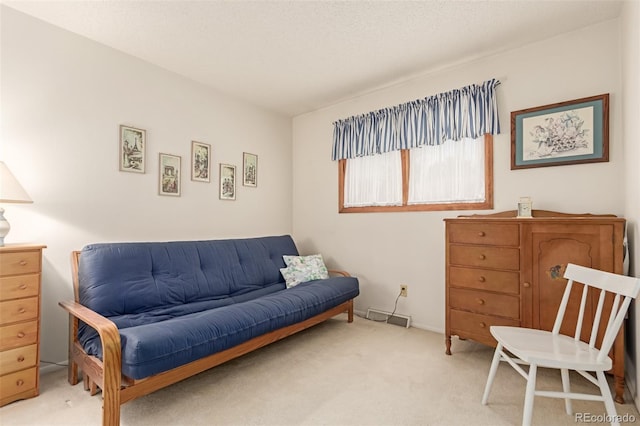 sitting room featuring light colored carpet