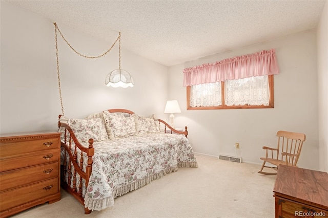 carpeted bedroom featuring a textured ceiling