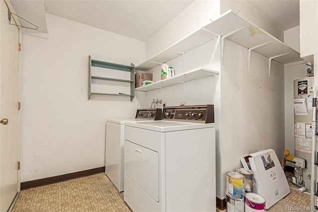 laundry area featuring water heater and separate washer and dryer