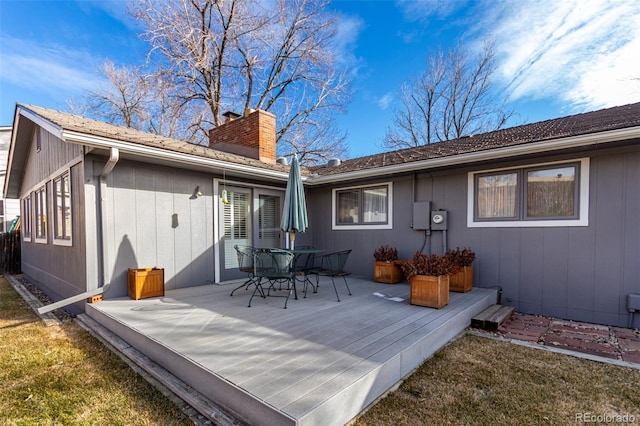 back of house with a lawn and a wooden deck