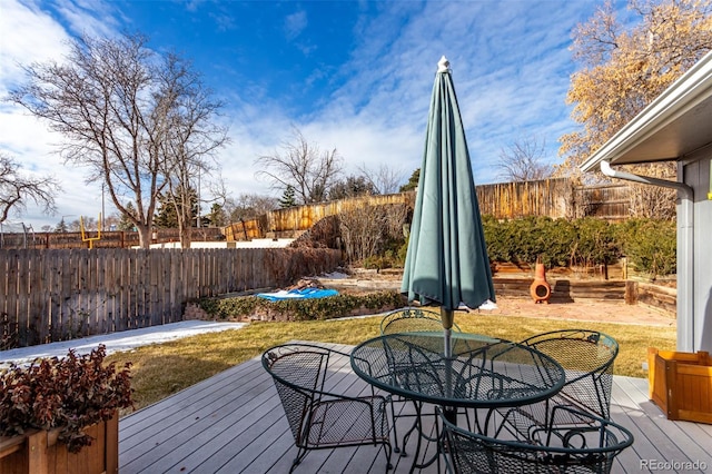 wooden terrace with a lawn