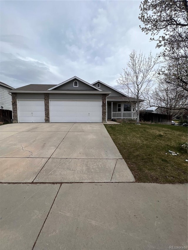 single story home featuring a porch, an attached garage, driveway, and a front lawn