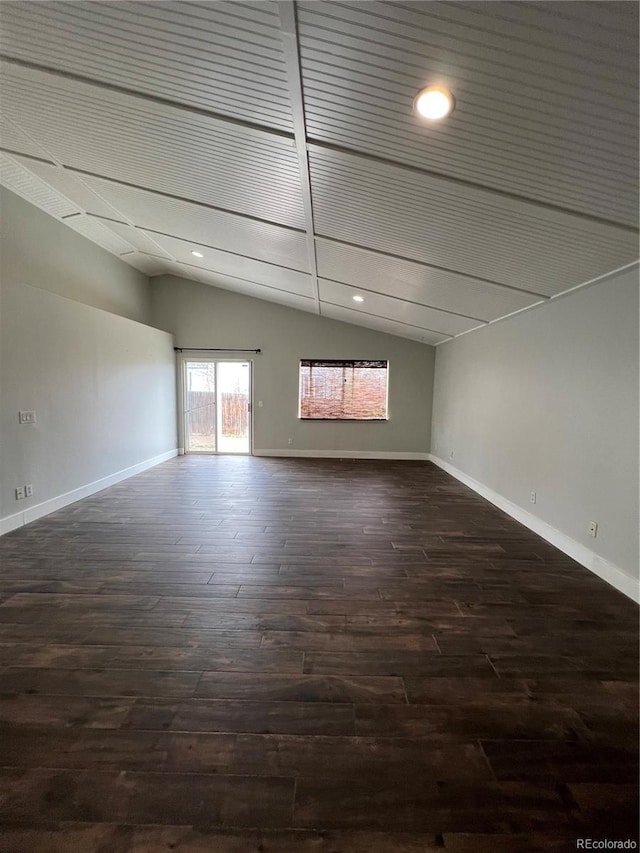 spare room with baseboards, recessed lighting, dark wood finished floors, and lofted ceiling