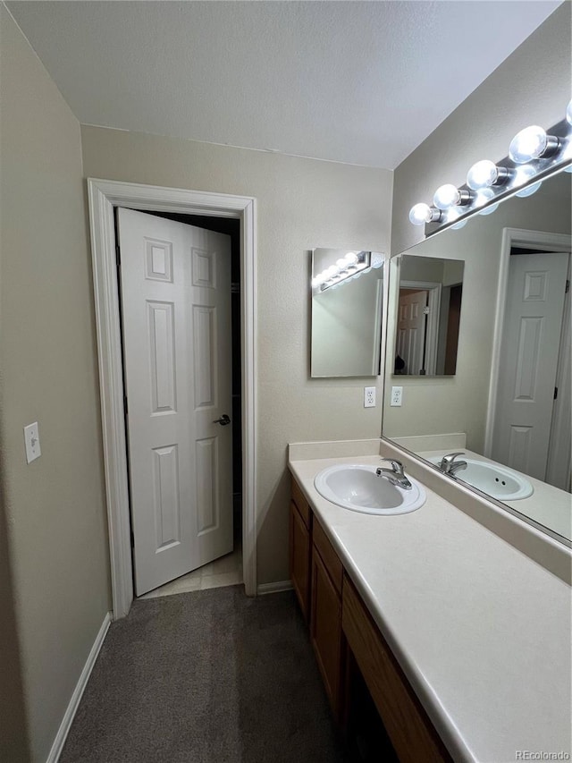 bathroom with vanity and baseboards