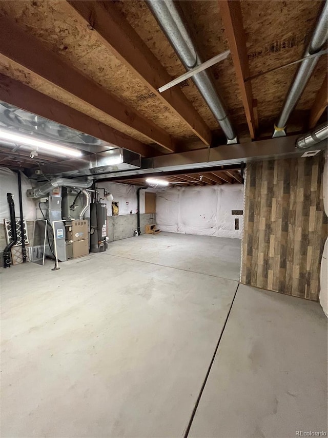 unfinished basement with heating unit and gas water heater