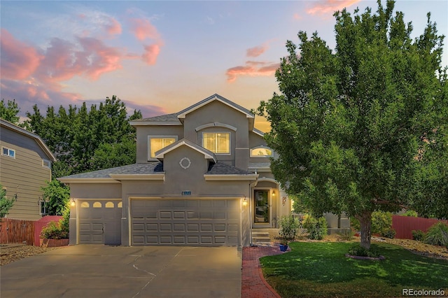 4737 E 127th Ave, Thornton, CO 80241 - view of front facade with stucco siding, concrete driveway, a shingled roof, and an attached garage