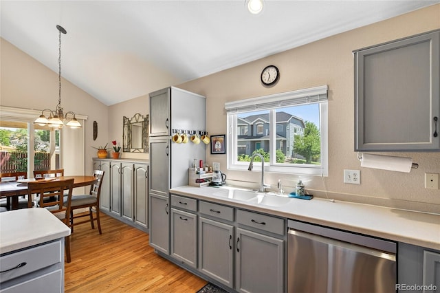 4737 E 127th Ave, Thornton, CO 80241 - kitchen with stainless steel dishwasher, gray cabinets, a chandelier, plenty of natural light, and vaulted ceiling