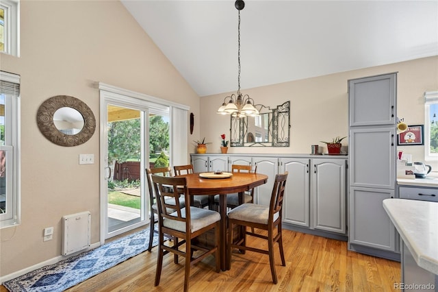 4737 E 127th Ave, Thornton, CO 80241 - dining space featuring a chandelier, light wood finished floors, and high vaulted ceiling