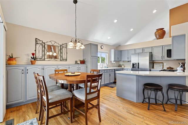 4737 E 127th Ave, Thornton, CO 80241 - dining room featuring light wood-style floors, a chandelier, recessed lighting, and high vaulted ceiling
