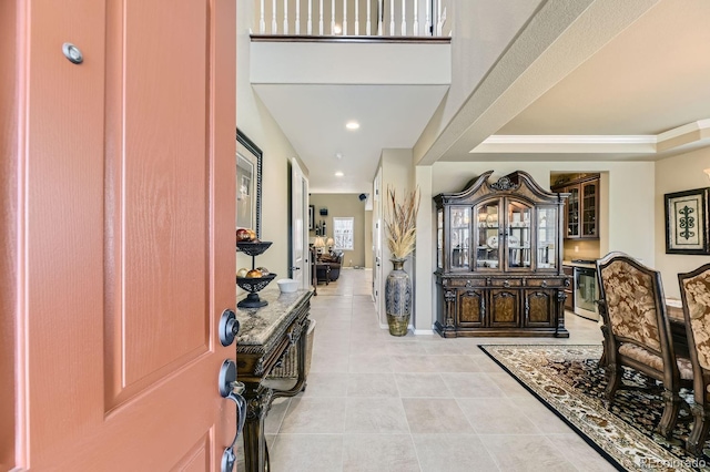 entryway with recessed lighting, light tile patterned flooring, and baseboards