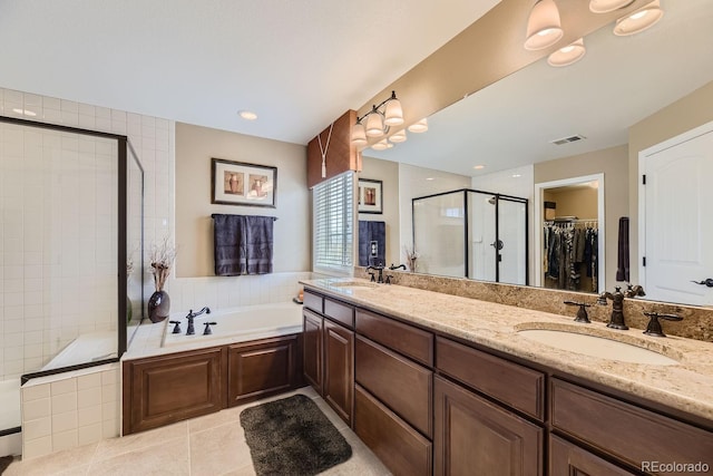 bathroom featuring a garden tub, a shower stall, visible vents, and a sink