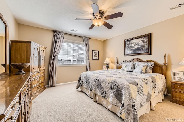 bedroom featuring light carpet, baseboards, visible vents, and ceiling fan