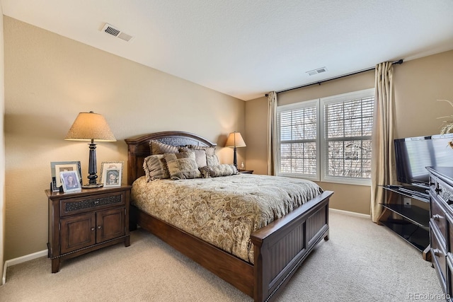 bedroom featuring light carpet, visible vents, and baseboards