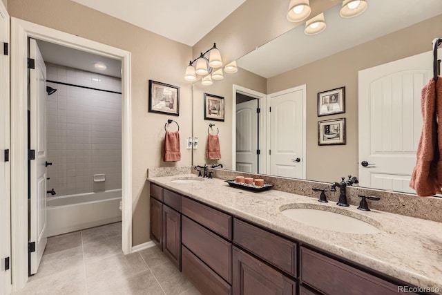 bathroom with double vanity, shower / bathtub combination, a sink, and tile patterned floors