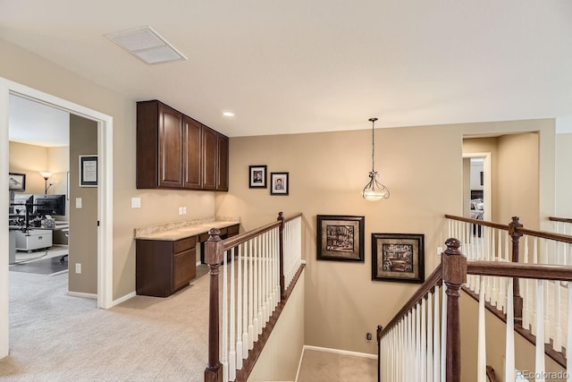 corridor with recessed lighting, visible vents, light carpet, an upstairs landing, and baseboards