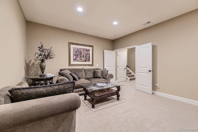 living room with recessed lighting, visible vents, light carpet, baseboards, and stairs