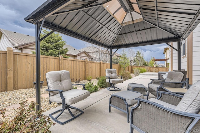 view of patio with a gazebo, a fenced backyard, and an outdoor living space