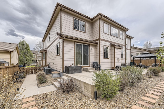 back of house with a patio area, fence, a gazebo, and central AC unit