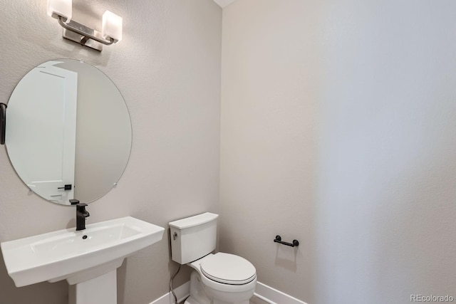 bathroom with toilet and sink