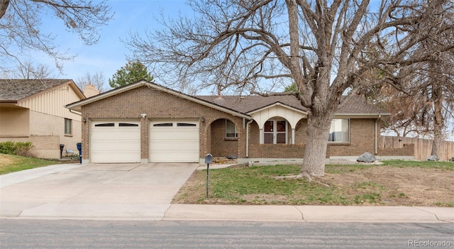 2696 S Yukon Ct, Lakewood, CO 80227 - ranch-style house featuring an attached garage, concrete driveway, and brick siding