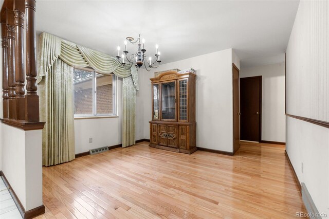 2696 S Yukon Ct, Lakewood, CO 80227 - dining space featuring light wood finished floors and a chandelier