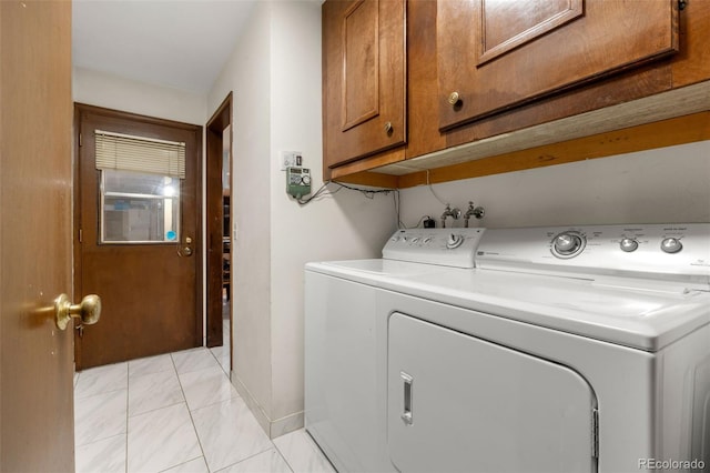 2696 S Yukon Ct, Lakewood, CO 80227 - laundry area with washer and clothes dryer, light marble finish flooring, and cabinet space
