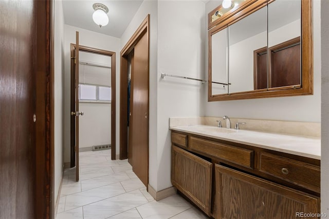 2696 S Yukon Ct, Lakewood, CO 80227 - bathroom featuring vanity and marble look tiles