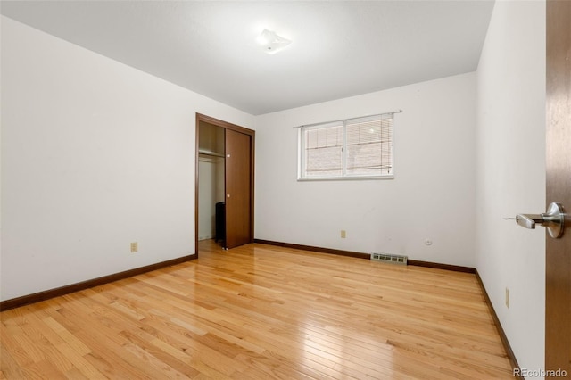 2696 S Yukon Ct, Lakewood, CO 80227 - unfurnished bedroom with light wood-style floors and a closet