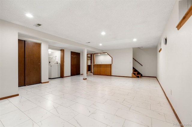 2696 S Yukon Ct, Lakewood, CO 80227 - spare room featuring stairway, recessed lighting, light marble finish flooring, and washer / clothes dryer