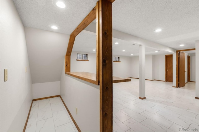 2696 S Yukon Ct, Lakewood, CO 80227 - hall featuring light marble finish floors, recessed lighting, and a textured ceiling