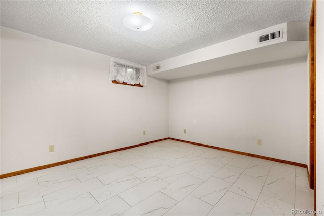 2696 S Yukon Ct, Lakewood, CO 80227 - finished basement featuring light marble finish floors and a textured ceiling