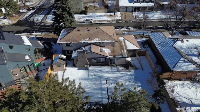 snowy aerial view with a residential view