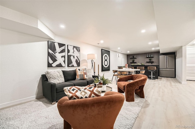 living room with baseboards, recessed lighting, and light wood-type flooring