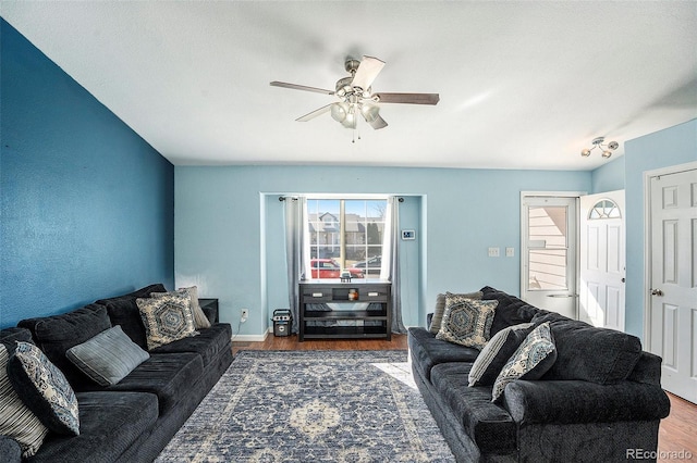 living area featuring wood finished floors and a ceiling fan