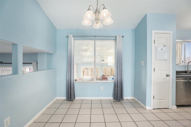 unfurnished dining area featuring an inviting chandelier, baseboards, and light tile patterned flooring