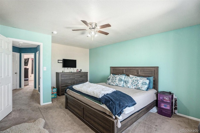 carpeted bedroom featuring ceiling fan and baseboards