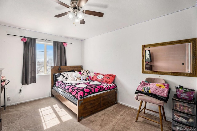 carpeted bedroom with a ceiling fan and baseboards