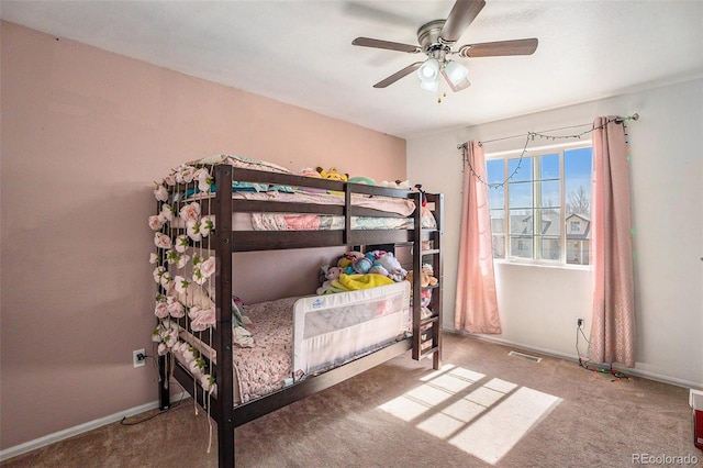 bedroom featuring carpet floors, baseboards, visible vents, and a ceiling fan