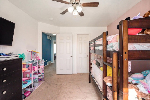 carpeted bedroom with visible vents and ceiling fan