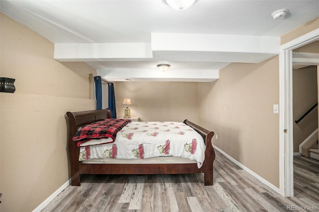 bedroom featuring baseboards and wood finished floors