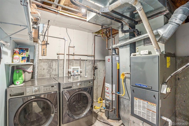 laundry area with laundry area, water heater, and separate washer and dryer