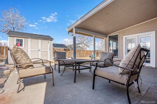 view of patio / terrace featuring a storage unit, an outdoor structure, and fence