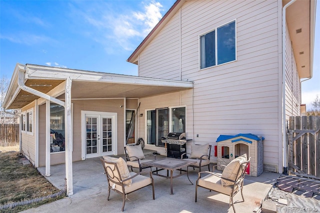 back of property featuring french doors, a patio area, and fence