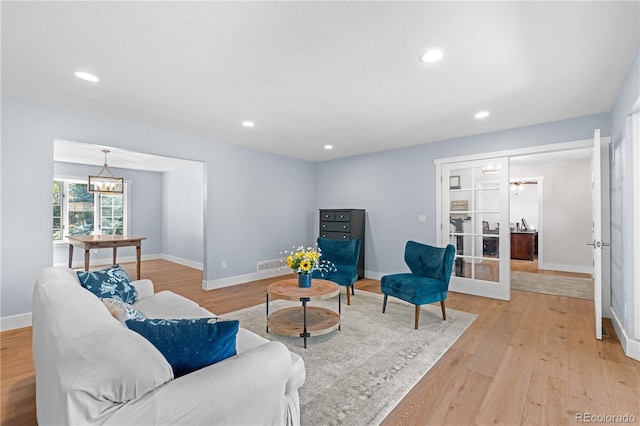 6795 E Kettle Ave, Centennial, CO 80112 - living area with light wood-type flooring, recessed lighting, and a chandelier
